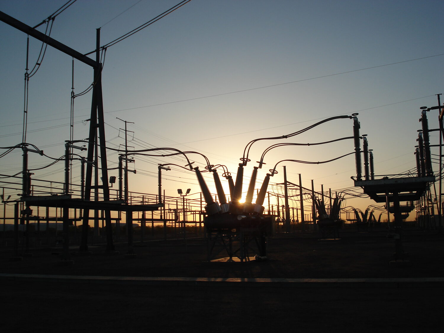 Schrader substation bus and breakers silhouetted at sunset, metro Phoenix, Arizona